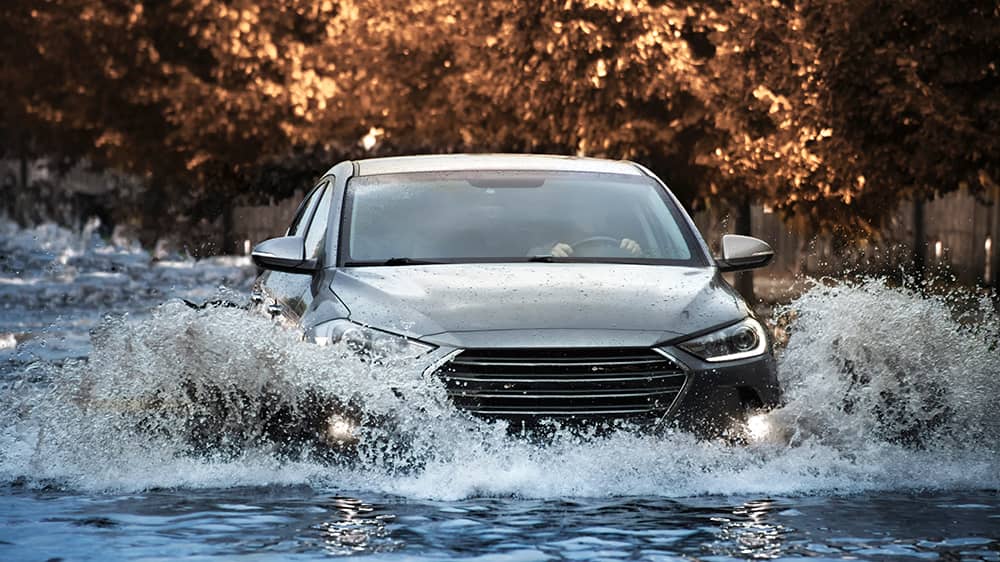 Car on flooded street after bad weather hurricane